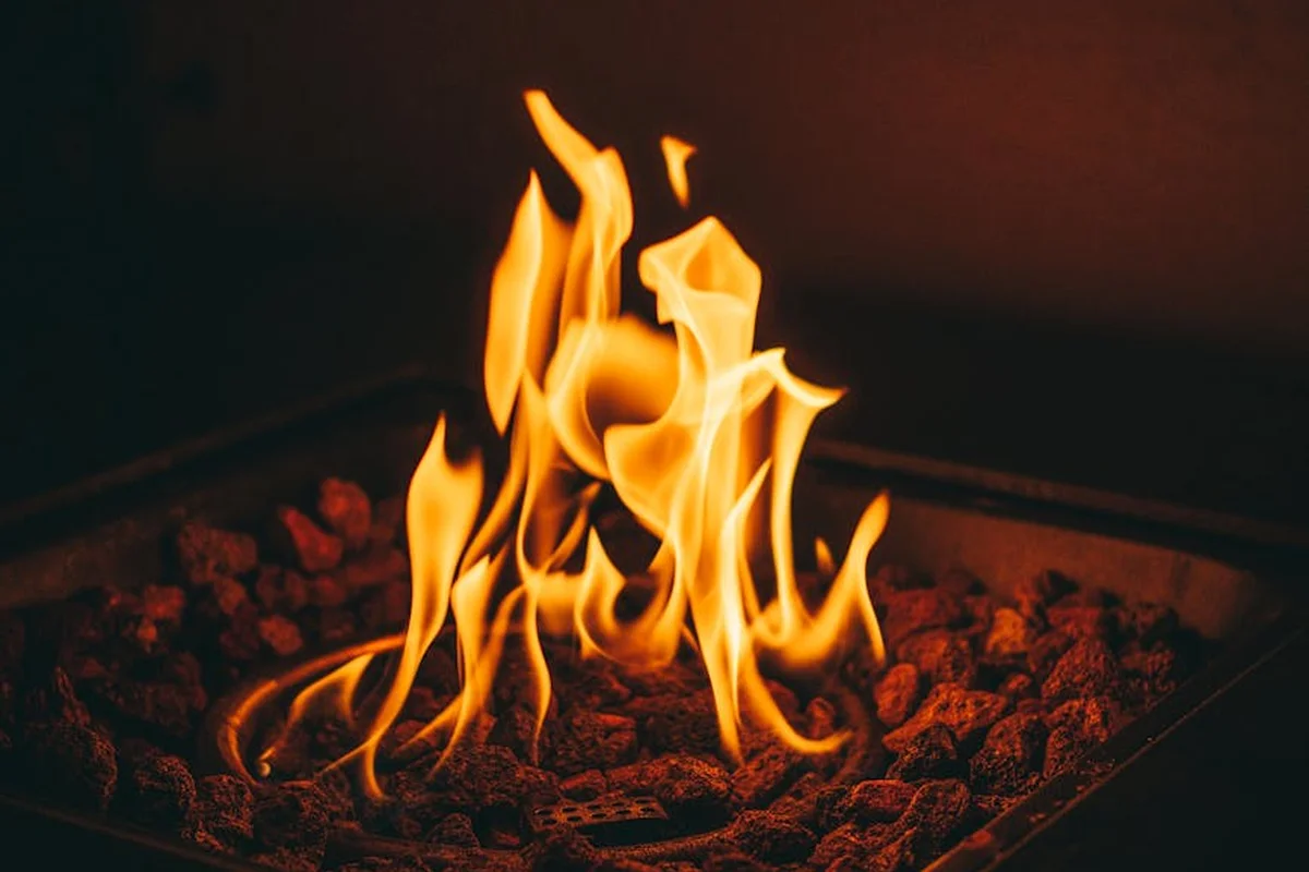 Flames rising from heated rocks inside a reptile heating device, illustrating the hazards of heat sources used in enclosures.