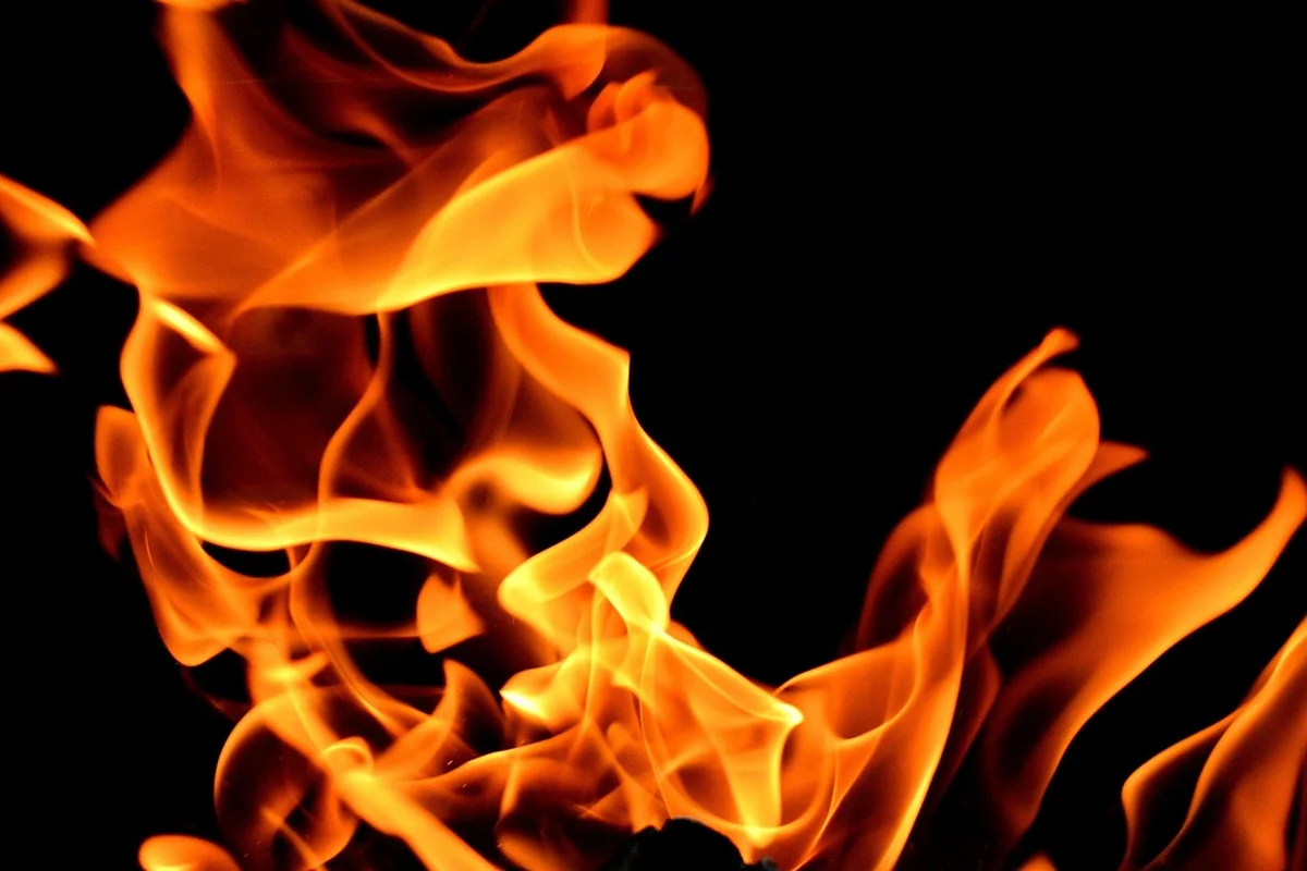 Flames against a dark background illustrating the hazards of improper heating in bearded dragon setups