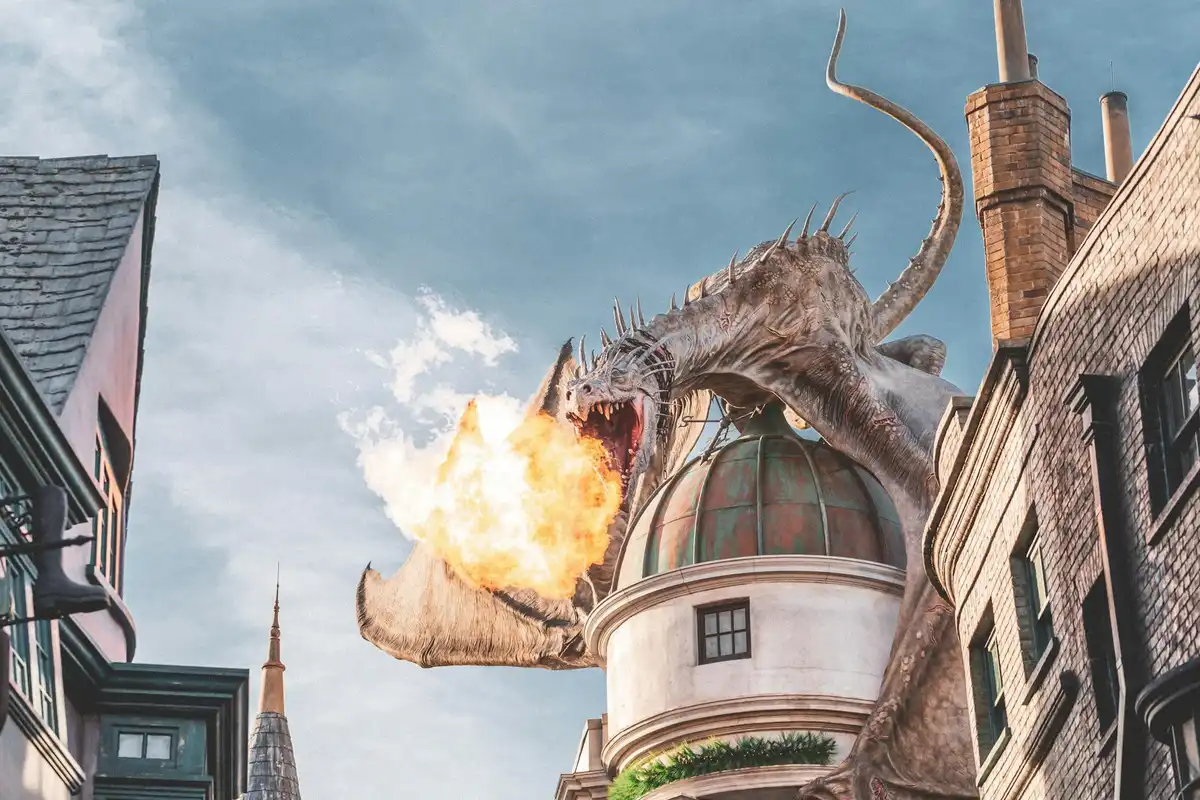 Fantasy dragon breathing fire between urban buildings